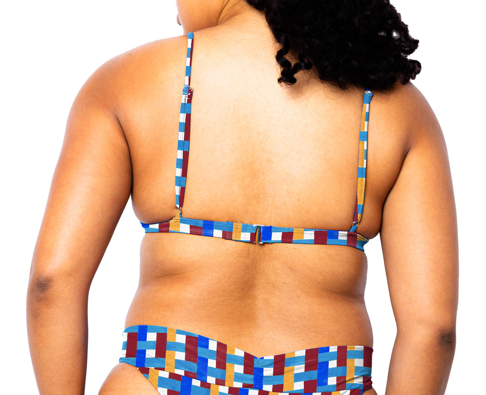Model facing back wearing Ally Bikini Top in Azulejo