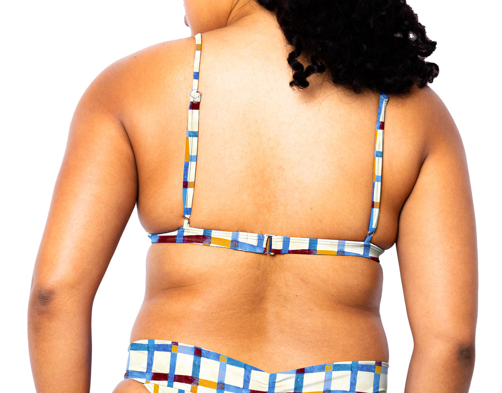 Model facing back wearing Ally Bikini Top in Checker Ecru