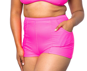 Model wearing MIGA Ally Boy Shorts in Neon Pink with matching MIGA Ally Bikini Top.