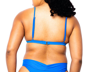 Model facing back wearing MIGA Ally Bikini Top in Cobalt Blue with Adjustable Straps and matching MIGA Ally Bikini Bottom.