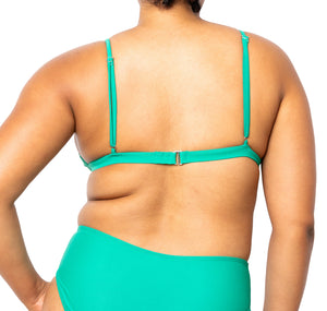Model facing back wearing MIGA Ally Bikini Top in Emerald Green with Adjustable Straps and matching MIGA Colette Bikini Bottom in Emerald Green.