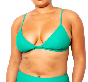Model wearing MIGA Ally Bikini Top in Emerald Green with Adjustable Straps and matching MIGA Colette Bikini Bottom in Emerald Green. 