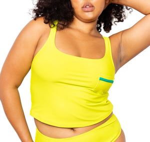 Model wearing lime green tankini top with scoop neck that comes with a front pocket with emerald green detail. She is also wearing matching lime green high-waisted bikini bottom with moderate coverage.