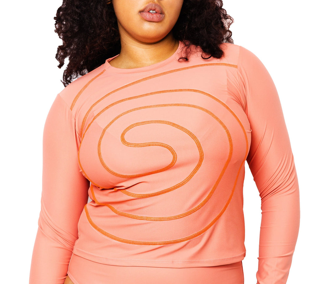 Model wearing Spiral Swim Shirt in Rose with matching Colette bikini bottom in Rose.