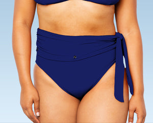 Model wearing Lydia maternity high-waisted bikini bottom with snap belt and matching Ally Bikini Bottom in navy blue.