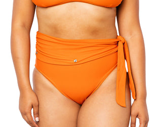 Model wearing Lydia high-waisted bikini bottom with snap belt and matching Ally Bikini Bottom in burnt orange.