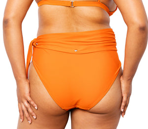 Model from back wearing Lydia high-waisted bikini bottom with snap belt and matching Ally Bikini Bottom in burnt orange.