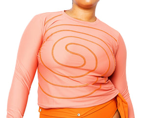 Model wearing Spiral Swim Shirt in Rose with Lydia Bikini Bottom in burnt orange.