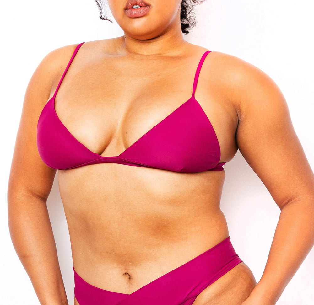 Model wearing MIGA Ally Bikini Top in Magenta with Adjustable Straps and matching MIGA Ally Bikini Bottom in Magenta.