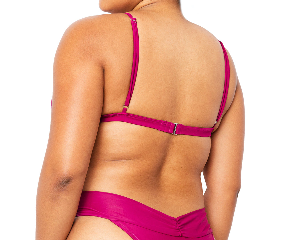 Model facing back wearing MIGA Ally Bikini Top in Magenta with Adjustable Straps and matching MIGA Ally Bikini Bottom in Magenta.